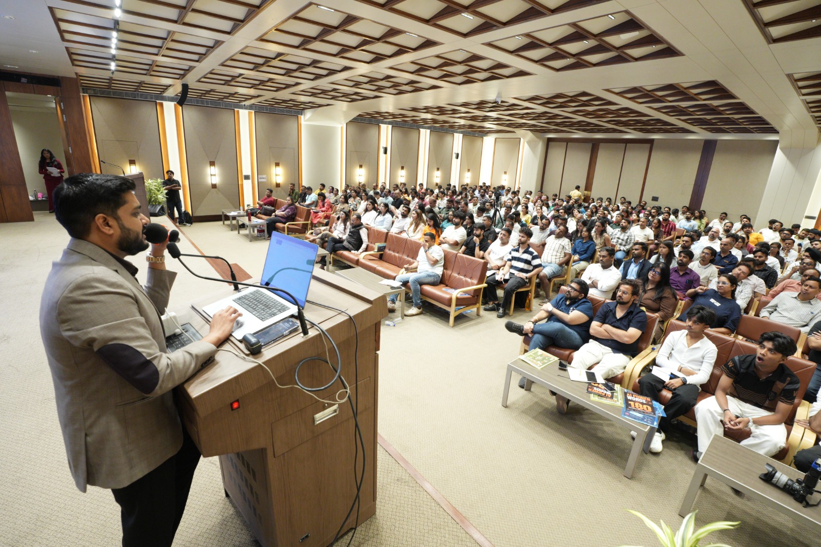 Lakshit Sethiya addressing a full auditorium from the podium